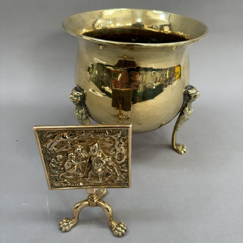 17 - A brass miniature tilt-top tripod table, the panel cast in relief with monkeys, 15.5cm high, togethe... 