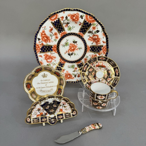 23 - A Royal Crown Derby coffee can and saucer, pattern 2451, date cipher for 1938, together with a plate... 