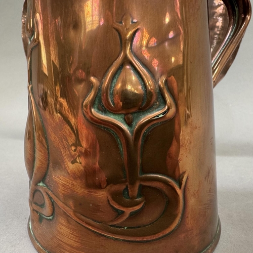 24 - An Art Nouveau copper lidded jug embossed with stylised scrolling seed heads by J S & S, registered ... 