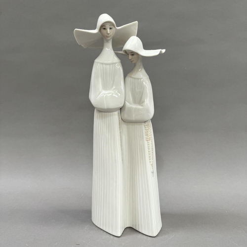 26 - A Lladro figure group of two nuns, 33cm high