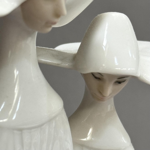 26 - A Lladro figure group of two nuns, 33cm high