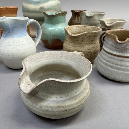 120 - A collection of studio and other pottery jugs including Moffat Pottery Scotland, ,Riverstone, Inglet... 