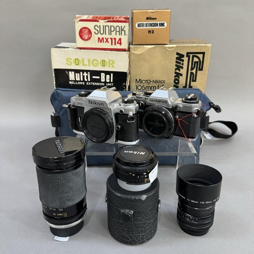 143 - A Nikon FG manual film SLR camera with various lenses including Tamron zoom lens and Nikon 50mm lens... 