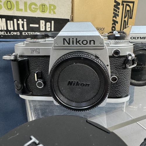 143 - A Nikon FG manual film SLR camera with various lenses including Tamron zoom lens and Nikon 50mm lens... 