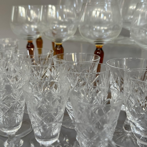 134 - Part suites of glass including ports, whiskies, brandies and a set of eight hock glasses with amber ... 