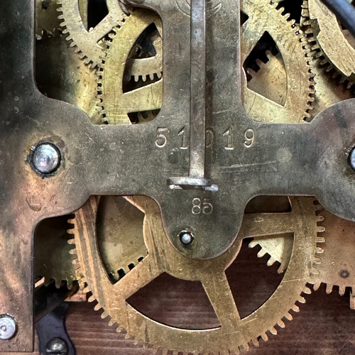 176 - A late 19th century oak mantel clock having a silver chaptering with black Roman numerals, applied g... 