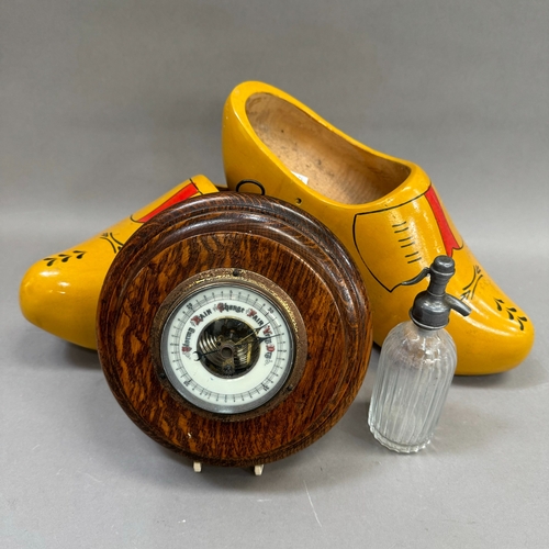 28 - A large pair of wooden clogs painted yellow and red together with a miniature soda syphon and an oak... 