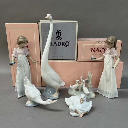 102 - Two Nao figures, girl with candle measuring 26cm together with a figure of a goose 34cm and a duck, ... 