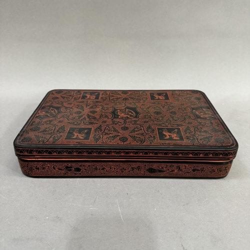 148 - A Chinese black and iron red lacquered box, 30.5cm x 9.5cm x 5cm