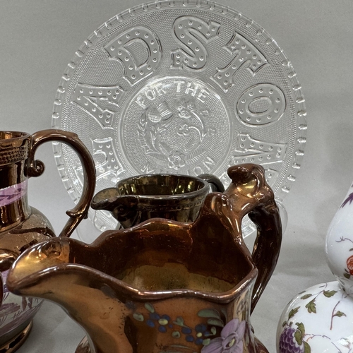 142 - Four Victorian copper lustre jugs, two coppered and enamel dishes cast with a scene of The Bank of I... 