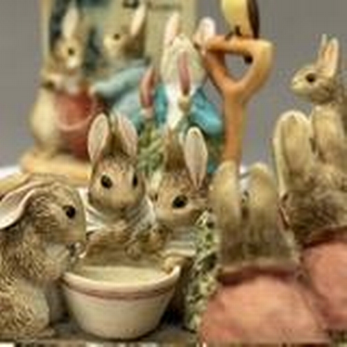 124 - A Royal Doulton Bunnykins dish, chip to the rim together with five resin Beatrix Potter figures (som... 