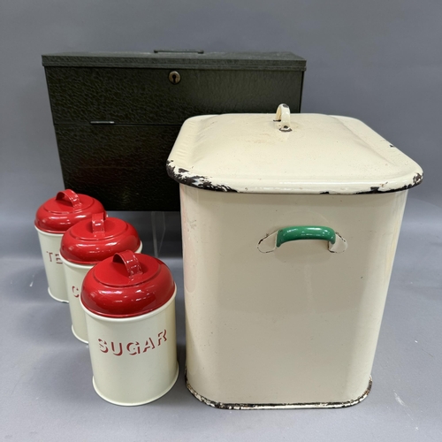 181 - A document box, an enamelled breadbin, three enamel storage cannisters with red enamel lids