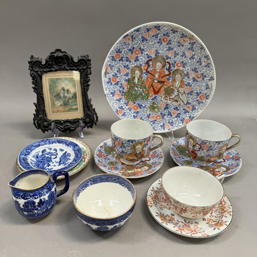 129 - A pair of Japanese teacups and saucers and a larger plate, another cabinet cup and saucer, willow pa... 