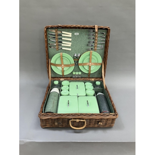 249 - A vintage wicker picnic hamper by Sirram, circa 1950/60s fitted with six knives, forks and teaspoons... 