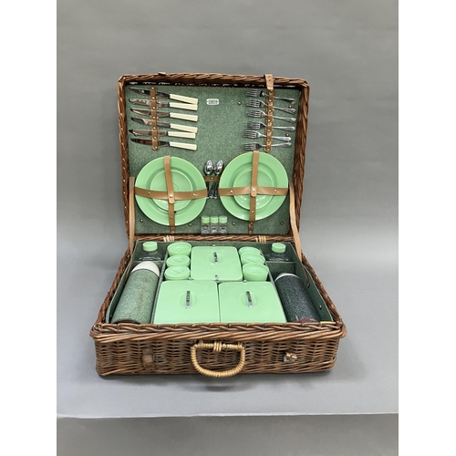 249 - A vintage wicker picnic hamper by Sirram, circa 1950/60s fitted with six knives, forks and teaspoons... 