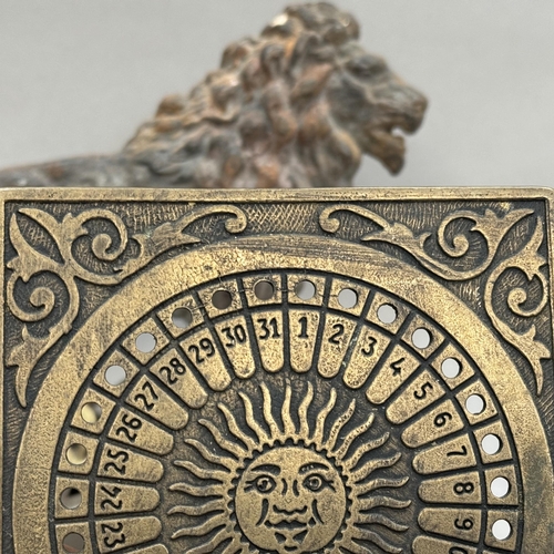 144 - A Victorian cast iron door stop or hearth ornament in the form of a lion, with the British lion bene... 