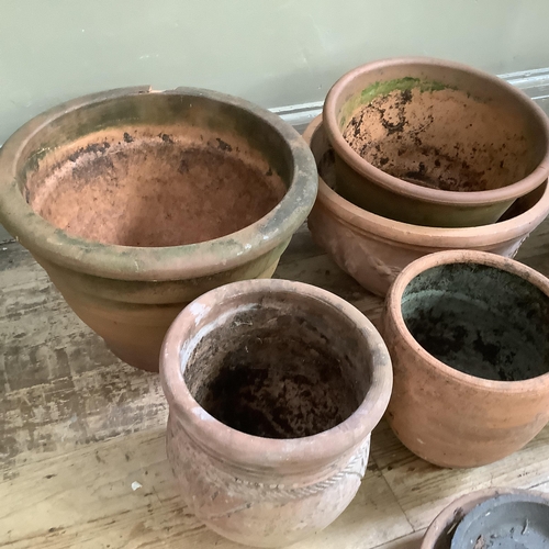 54 - A collection of terracotta plant pots measuring from 27.5cm high to 10cm together with a stone mix p... 