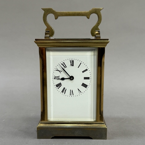 5 - A gilt brass carriage clock, white enamel dial and black Roman numerals, 15cm over handle