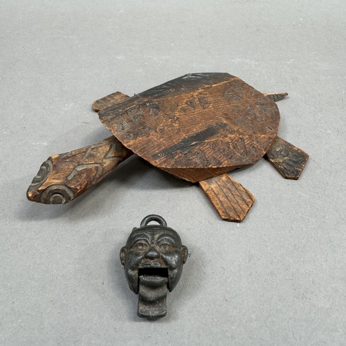 6 - A wooden model of a turtle with a moving head and feet (one foot missing) together with a small meta... 