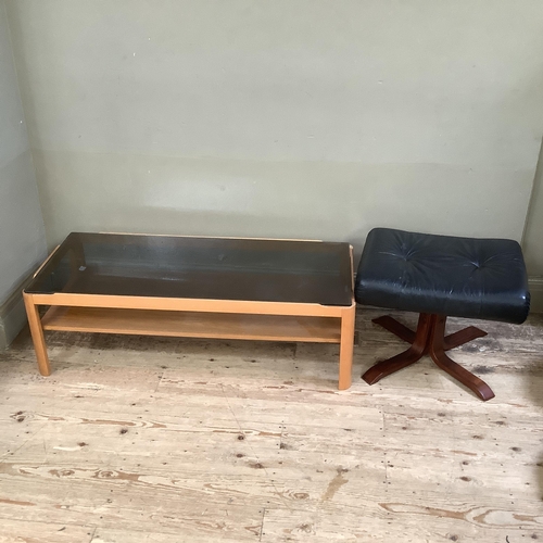 74 - A smoked glass and teak two tier coffee table 112cm x 48cm x 35cm together with a Stressless style b... 