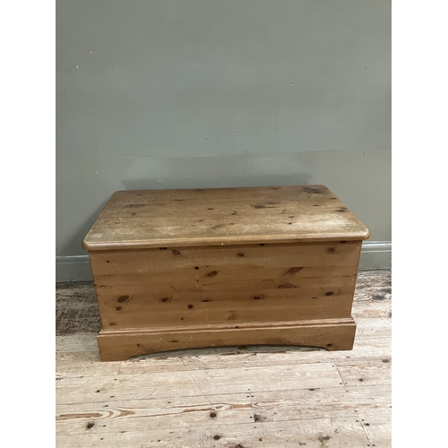 82 - A modern pine blanket chest with brass cup handles and on plinth base, 97cm x 53cm x 50cm