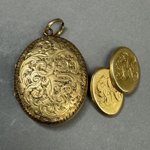 211 - A Victorian oval locket in 9ct gold, foliate scroll engraved with vacant shielded shaped cartouche, ... 