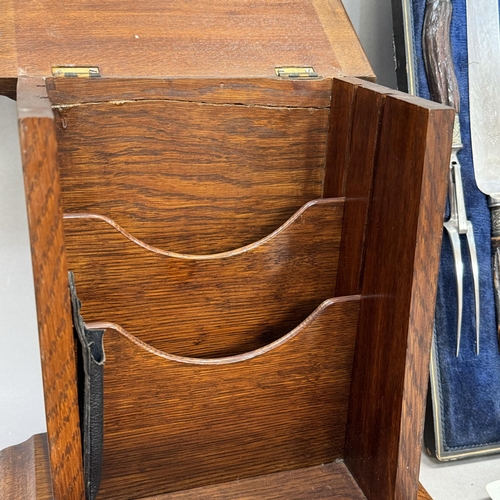 110 - A set of three antler handled carvers in fitted case, an oak stationery box with lift up lid and fal... 