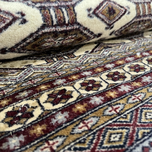 192 - A Caucasian rug, the dark camel ground of conjoined lozenge within multiple borders, colours in dark... 