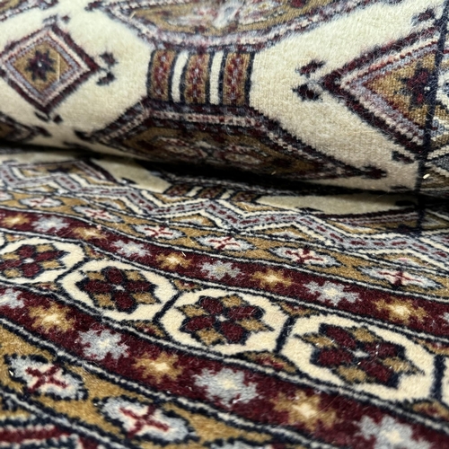 192 - A Caucasian rug, the dark camel ground of conjoined lozenge within multiple borders, colours in dark... 