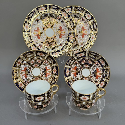 21 - Two Royal Crown Derby trios of cup, saucer and tea plates