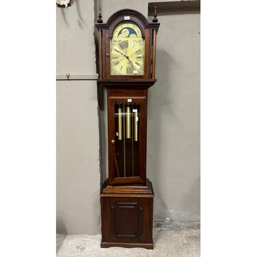 79 - A reproduction mahogany longcase clock having an arched dial with moon phase, the chaptering with Ro... 