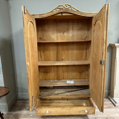 86 - A Victorian pine two drawer armoire with arched profile with pierced pediment over two arch indented... 