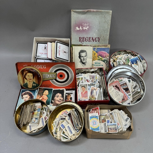 182 - A collection of cigarette and trade cards contained in various printed tins together with movie star... 