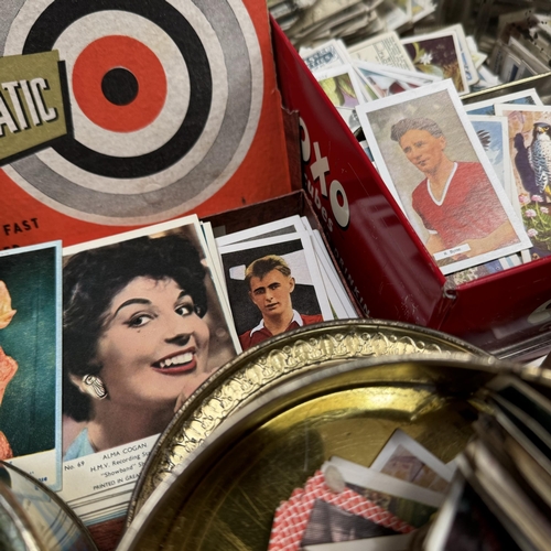 182 - A collection of cigarette and trade cards contained in various printed tins together with movie star... 