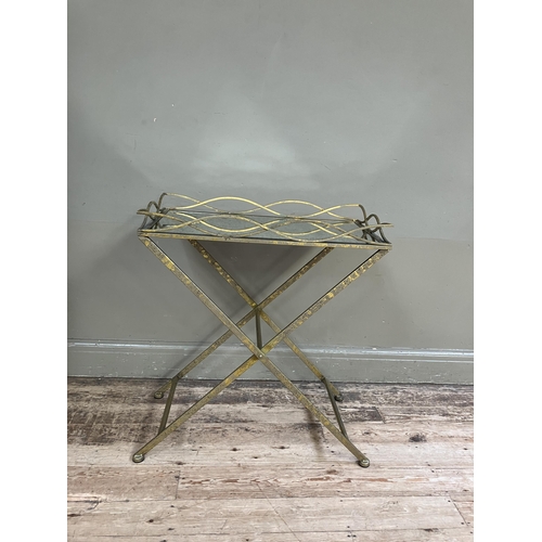 246 - A gilt metal mirror topped tray table on cross legs, 69cm x 38cm