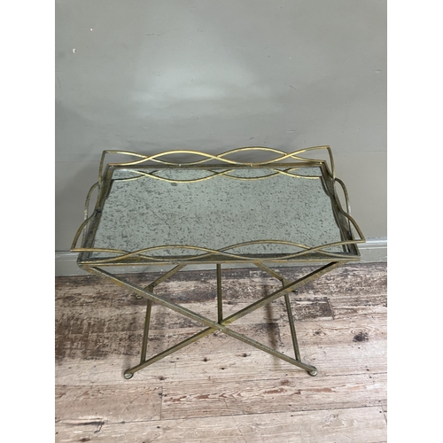 246 - A gilt metal mirror topped tray table on cross legs, 69cm x 38cm