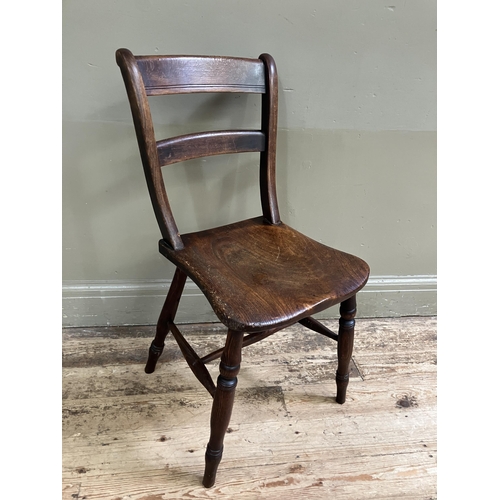 247 - A late 19th/early 20th century fruitwood kitchen chair with bar back and tie rail, saddle shaped sea... 