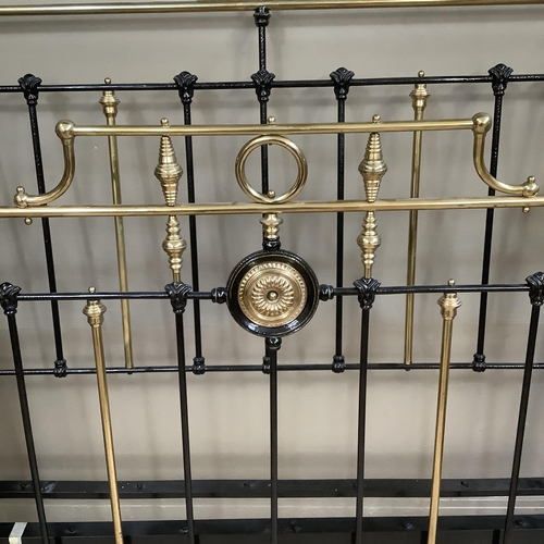 275 - A Victorian brass and iron double bedstead with gallery rail and measuring approximately 5 feet by 6... 