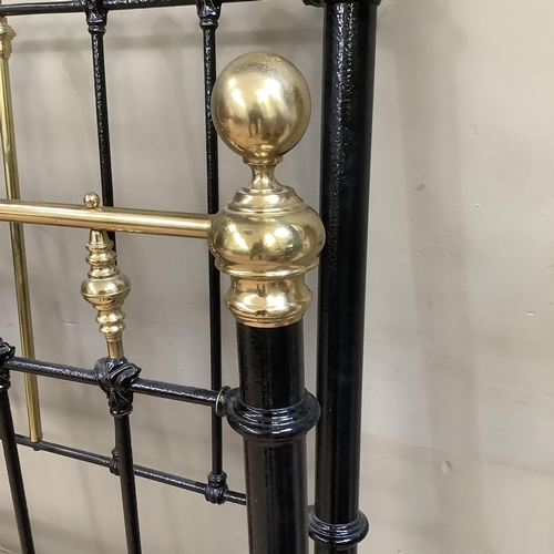 275 - A Victorian brass and iron double bedstead with gallery rail and measuring approximately 5 feet by 6... 