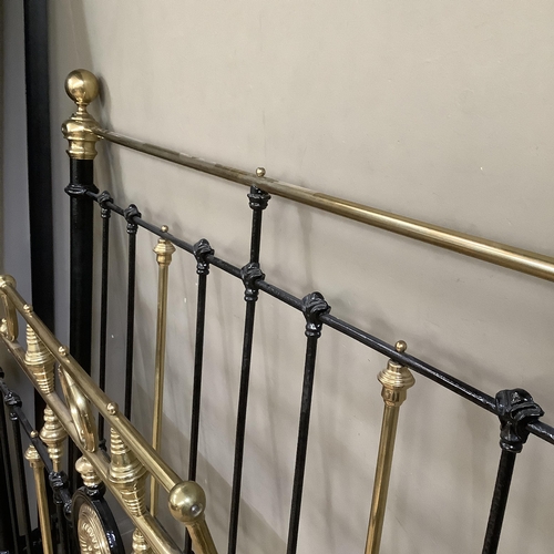 275 - A Victorian brass and iron double bedstead with gallery rail and measuring approximately 5 feet by 6... 