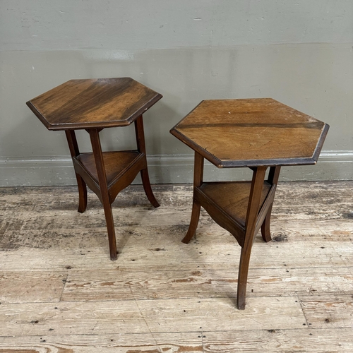 279 - A pair of hexagonal walnut occasional tables with triangular under tier and apron, on square legs