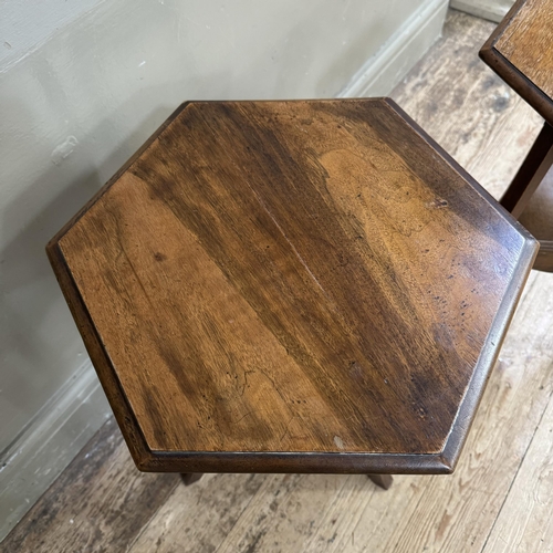 279 - A pair of hexagonal walnut occasional tables with triangular under tier and apron, on square legs