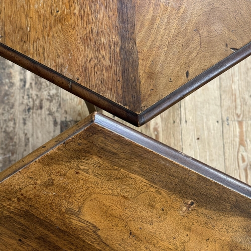 279 - A pair of hexagonal walnut occasional tables with triangular under tier and apron, on square legs