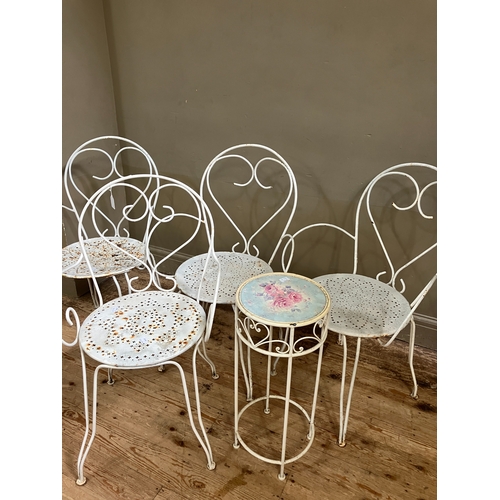 222 - A set of four vintage wire work chairs and a similar table with rose decorated top