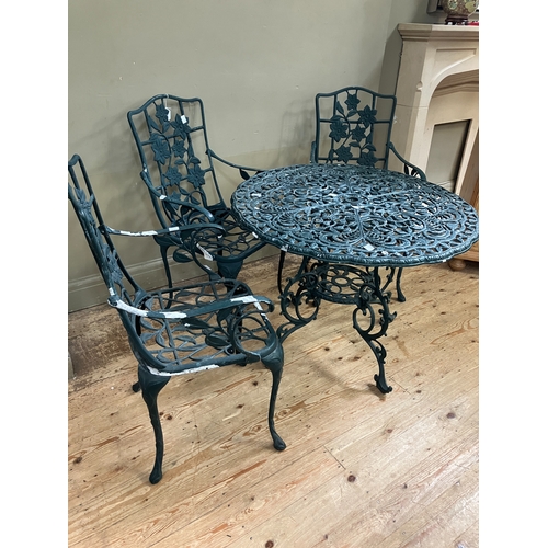 224 - A green metal patio table and three armchairs