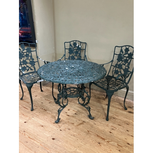 224 - A green metal patio table and three armchairs