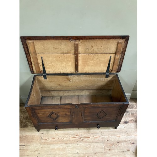 300 - A 19th century oak kist having a twin indented panel front with diamond motifs on panel shaped sides... 