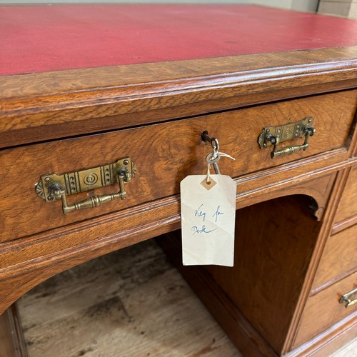 291 - A Victorian oak kneehole desk having three drawers across and three further drawers to either side o... 