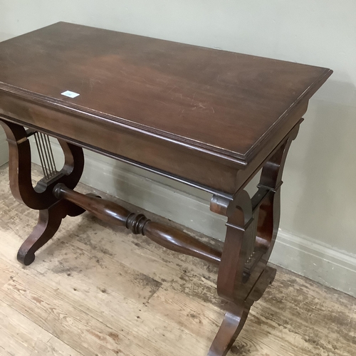 236 - A mahogany rectangular side table on lyre shaped supports and with refectory supports and turned str... 