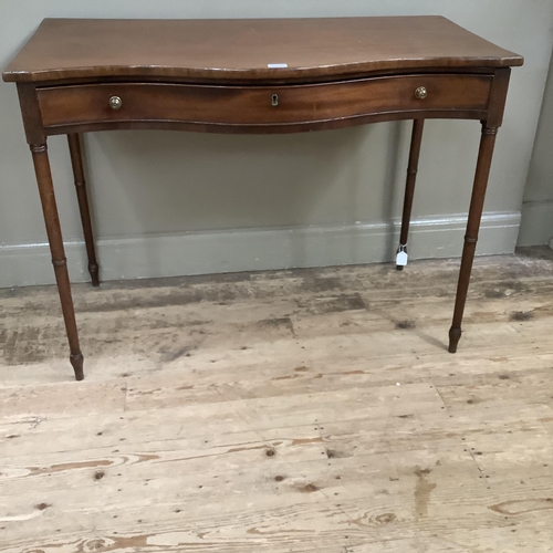 237 - A 19th century mahogany side table of serpentine outline, having a drawer to the frieze with brass k... 